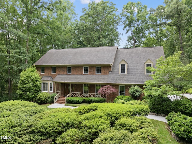 2300 Valley Forge Dr, Raleigh, NC 27615 - view of front of property with a porch, brick siding, and a shingled roof