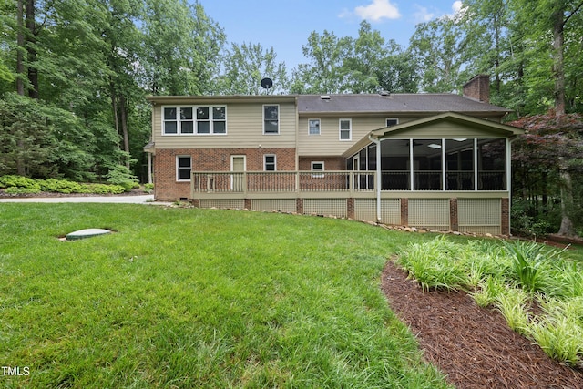 2300 Valley Forge Dr, Raleigh, NC 27615 - back of property featuring brick siding, a chimney, a yard, a sunroom, and a wooden deck