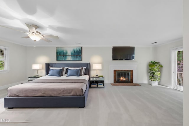 2300 Valley Forge Dr, Raleigh, NC 27615 - bedroom featuring a brick fireplace, ornamental molding, a ceiling fan, and carpet flooring