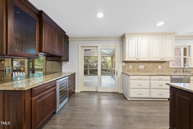 2300 Valley Forge Dr, Raleigh, NC 27615 - kitchen with beverage cooler, light stone counters, plenty of natural light, tasteful backsplash, and ornamental molding