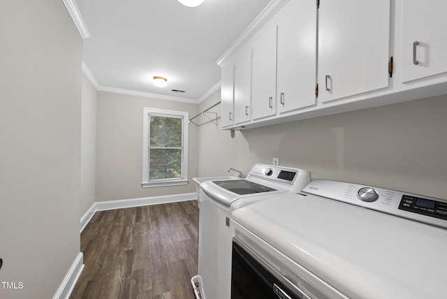 2300 Valley Forge Dr, Raleigh, NC 27615 - laundry room with cabinet space, washing machine and dryer, ornamental molding, and dark wood-style floors