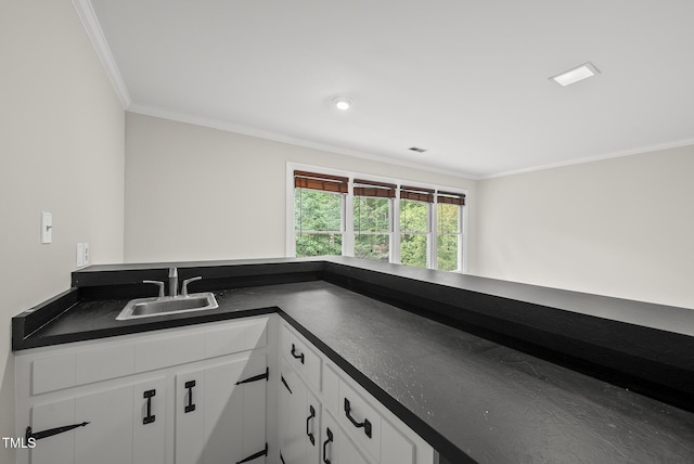 2300 Valley Forge Dr, Raleigh, NC 27615 - kitchen with dark countertops, white cabinetry, and ornamental molding