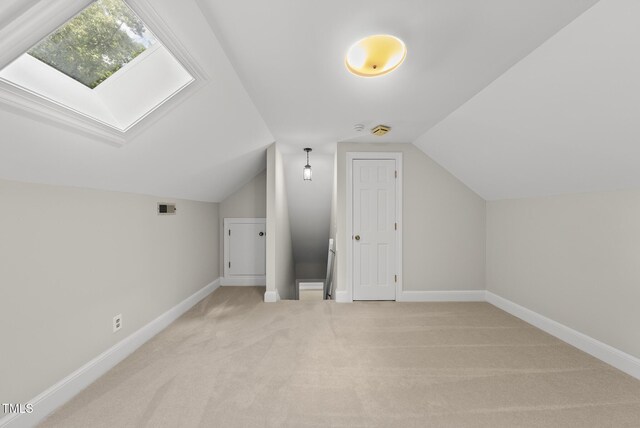 2300 Valley Forge Dr, Raleigh, NC 27615 - additional living space with light carpet, a skylight, and vaulted ceiling