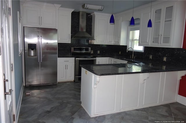 706 Riverside Dr, Lumberton, NC 28358 - kitchen featuring stainless steel appliances, wall chimney exhaust hood, a sink, a peninsula, and white cabinetry
