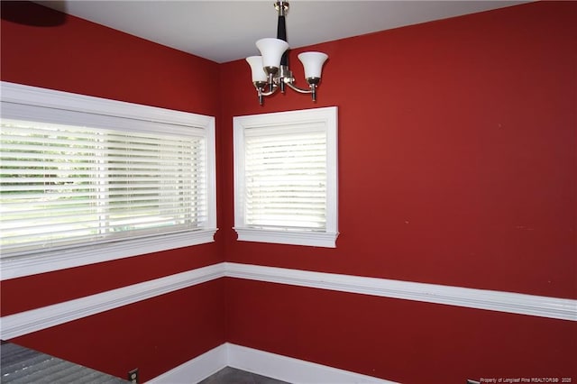 706 Riverside Dr, Lumberton, NC 28358 - unfurnished dining area featuring a chandelier and baseboards