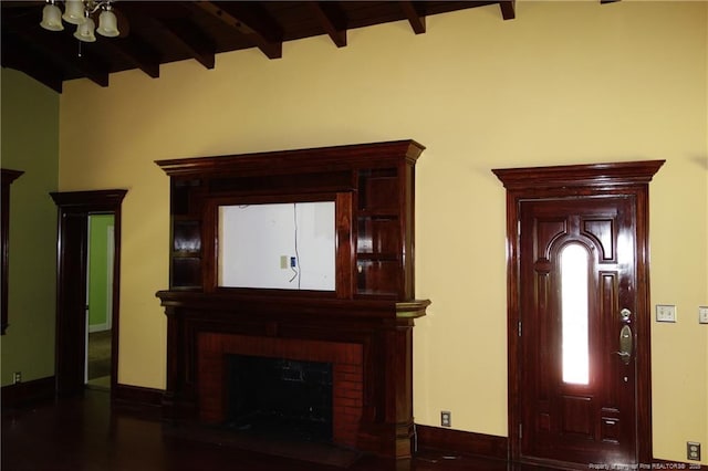 706 Riverside Dr, Lumberton, NC 28358 - foyer featuring beam ceiling, a brick fireplace, and baseboards