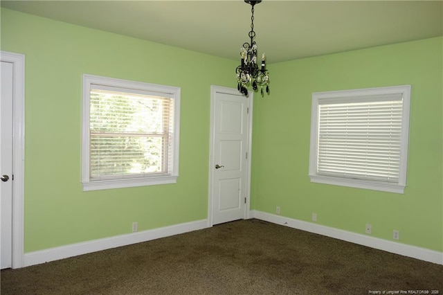 706 Riverside Dr, Lumberton, NC 28358 - unfurnished room featuring dark carpet, a chandelier, and baseboards