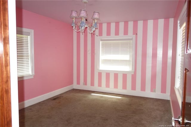 706 Riverside Dr, Lumberton, NC 28358 - spare room with carpet floors, a chandelier, plenty of natural light, and wallpapered walls