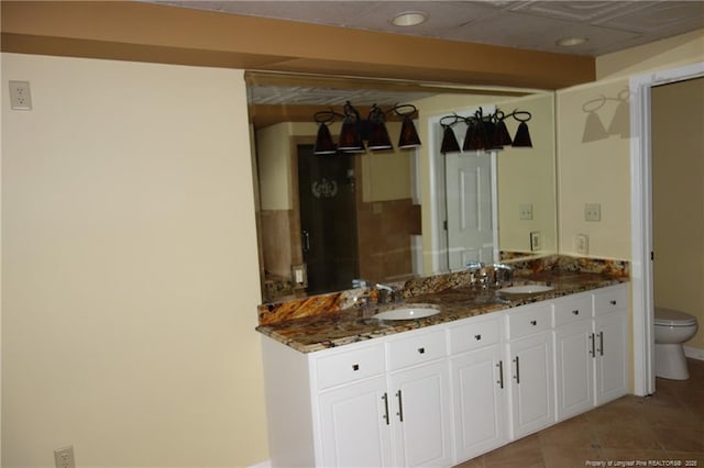 706 Riverside Dr, Lumberton, NC 28358 - full bathroom featuring toilet, double vanity, tile patterned flooring, and baseboards