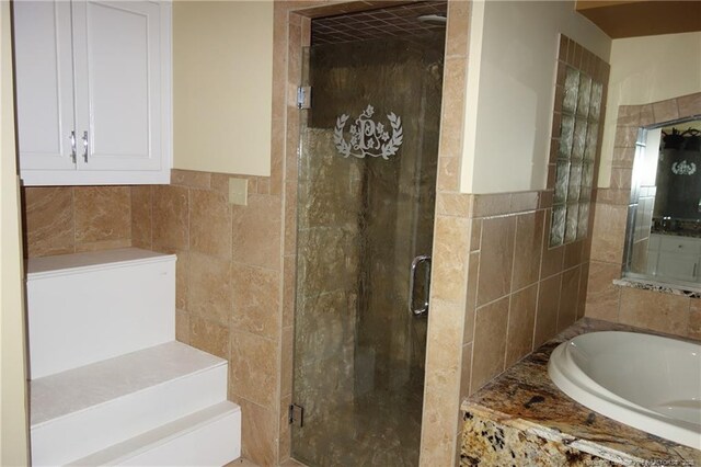 706 Riverside Dr, Lumberton, NC 28358 - full bathroom featuring tile walls, a bath, and a shower stall