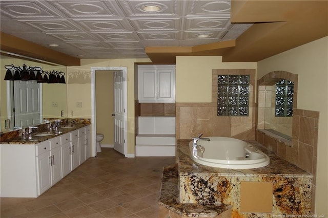 706 Riverside Dr, Lumberton, NC 28358 - bathroom featuring a bath, double vanity, toilet, and an ornate ceiling