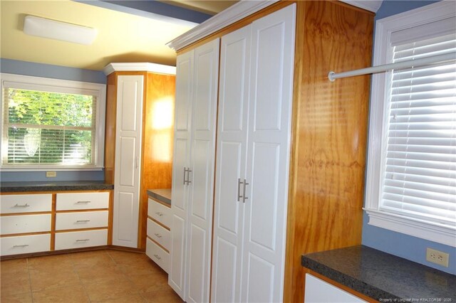 706 Riverside Dr, Lumberton, NC 28358 - kitchen featuring dark countertops, white cabinetry, and light tile patterned floors