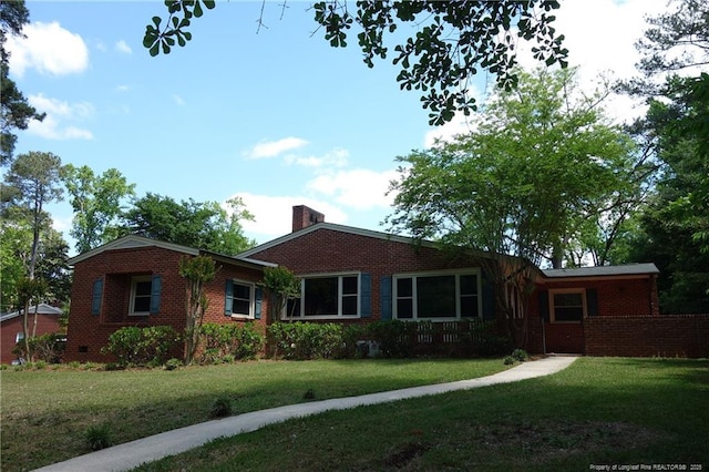 706 Riverside Dr, Lumberton, NC 28358 - view of front facade featuring brick siding, a front lawn, and a chimney