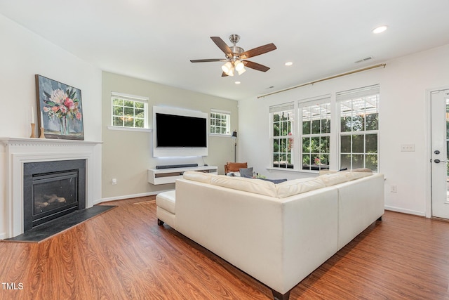 233 Hammond Wood Pl, Morrisville, NC 27560 - living area featuring wood finished floors, a ceiling fan, a glass covered fireplace, recessed lighting, and baseboards