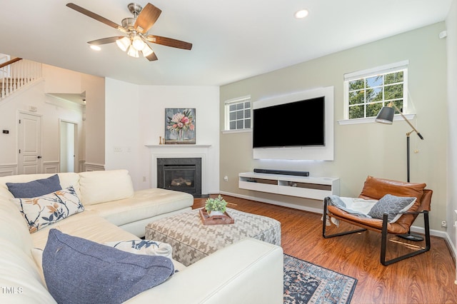 233 Hammond Wood Pl, Morrisville, NC 27560 - living room with wood finished floors, a ceiling fan, a glass covered fireplace, baseboards, and recessed lighting
