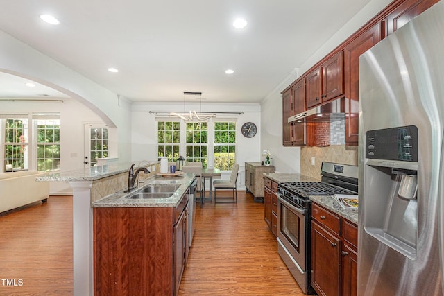 233 Hammond Wood Pl, Morrisville, NC 27560 - kitchen with stainless steel appliances, a sink, wood finished floors, an island with sink, and recessed lighting