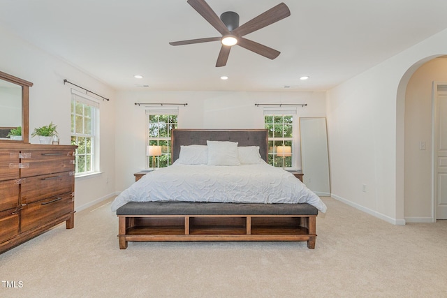 233 Hammond Wood Pl, Morrisville, NC 27560 - bedroom with arched walkways, light carpet, multiple windows, and recessed lighting