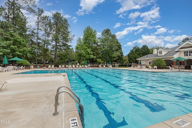 233 Hammond Wood Pl, Morrisville, NC 27560 - community pool with a patio and view of wooded area