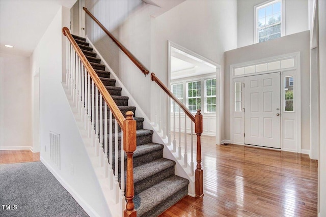 1420 Lagerfeld Way, Wake Forest, NC 27587 - foyer entrance with stairway, wood-type flooring, a high ceiling, and baseboards