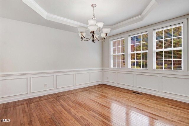 1420 Lagerfeld Way, Wake Forest, NC 27587 - spare room featuring crown molding, a chandelier, a tray ceiling, light wood-style floors, and a decorative wall