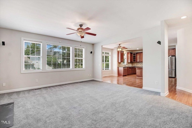 1420 Lagerfeld Way, Wake Forest, NC 27587 - unfurnished living room featuring light carpet, ceiling fan, baseboards, and recessed lighting