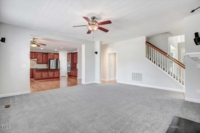 1420 Lagerfeld Way, Wake Forest, NC 27587 - unfurnished living room featuring light carpet, a ceiling fan, stairway, baseboards, and recessed lighting