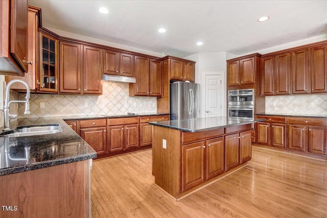 1420 Lagerfeld Way, Wake Forest, NC 27587 - kitchen featuring stainless steel appliances, a sink, a kitchen island, under cabinet range hood, and tasteful backsplash