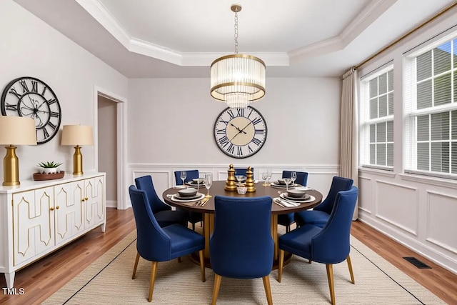 1420 Lagerfeld Way, Wake Forest, NC 27587 - dining space featuring a tray ceiling, a chandelier, light wood-style floors, crown molding, and wainscoting