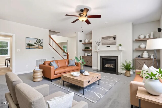 1420 Lagerfeld Way, Wake Forest, NC 27587 - carpeted living room with built in features, ceiling fan, stairway, and a fireplace with flush hearth