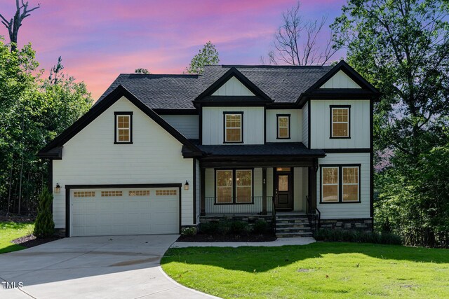 66 Sweet Meadow Ln, Pittsboro, NC 27312 - modern farmhouse style home featuring covered porch, concrete driveway, a shingled roof, a lawn, and an attached garage