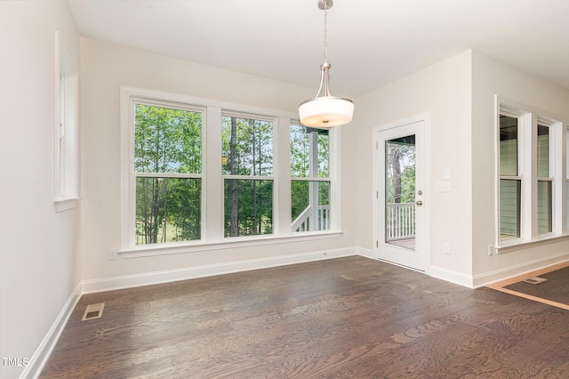 66 Sweet Meadow Ln, Pittsboro, NC 27312 - unfurnished dining area with baseboards and dark wood-style flooring