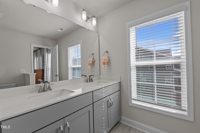 518 Toran Dr, Wake Forest, NC 27587 - full bathroom featuring toilet, double vanity, and baseboards