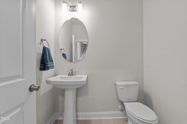 518 Toran Dr, Wake Forest, NC 27587 - bathroom featuring toilet, baseboards, wood finished floors, and a sink