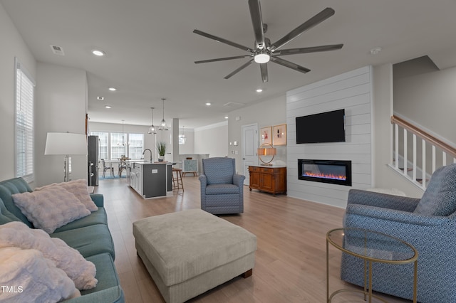 518 Toran Dr, Wake Forest, NC 27587 - living room with light wood finished floors, a fireplace, recessed lighting, and ceiling fan