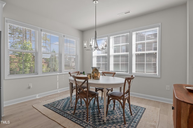 518 Toran Dr, Wake Forest, NC 27587 - dining area featuring a chandelier, light wood-type flooring, and baseboards