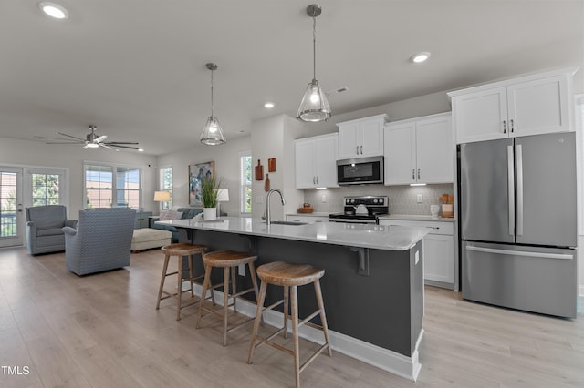 518 Toran Dr, Wake Forest, NC 27587 - kitchen featuring stainless steel appliances, a sink, a kitchen bar, recessed lighting, and white cabinets