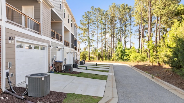 518 Toran Dr, Wake Forest, NC 27587 - view of side of property featuring central air condition unit, an attached garage, and driveway