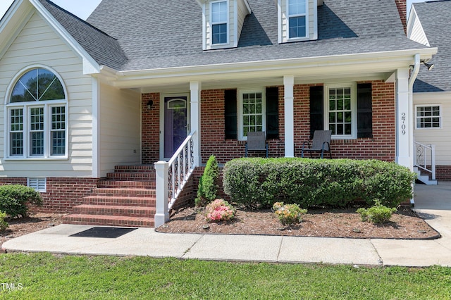 2709 Les Paul Ln, Apex, NC 27539 - view of front of house featuring brick siding, a porch, and a shingled roof