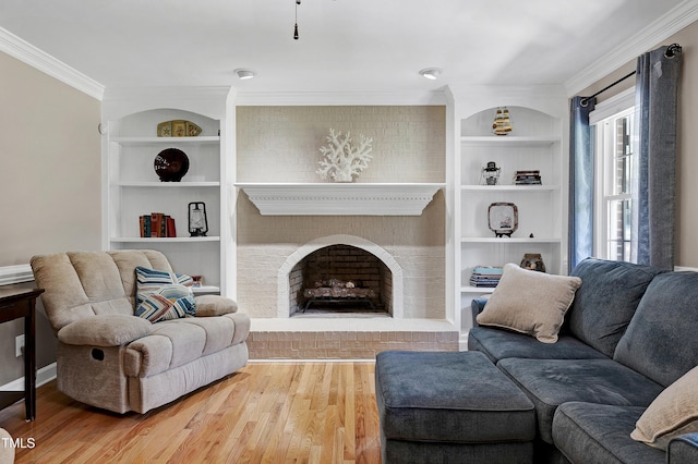 2709 Les Paul Ln, Apex, NC 27539 - living area with crown molding, wood finished floors, built in features, and a fireplace