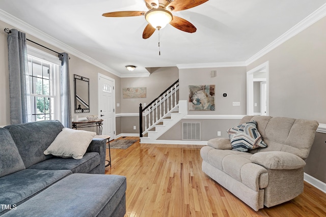 2709 Les Paul Ln, Apex, NC 27539 - living room featuring stairway, ornamental molding, light wood-style flooring, baseboards, and ceiling fan