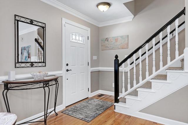 2709 Les Paul Ln, Apex, NC 27539 - entrance foyer featuring crown molding, wood finished floors, stairway, and baseboards