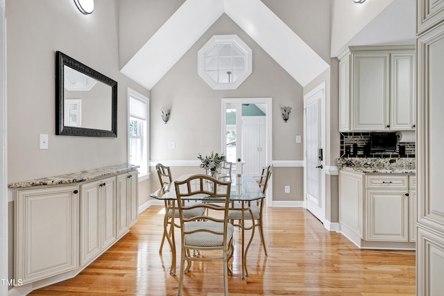 2709 Les Paul Ln, Apex, NC 27539 - dining room with light wood-style floors, high vaulted ceiling, and baseboards