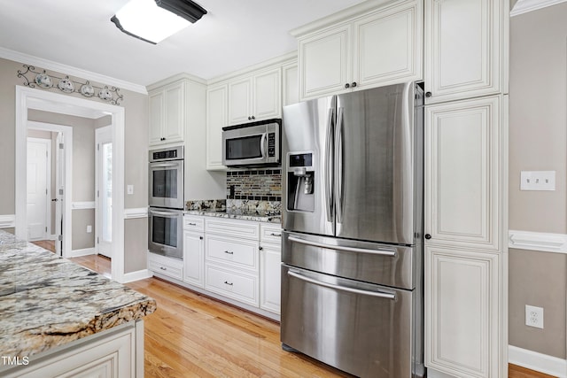 2709 Les Paul Ln, Apex, NC 27539 - kitchen with stainless steel appliances, light wood-style flooring, light stone countertops, tasteful backsplash, and white cabinets