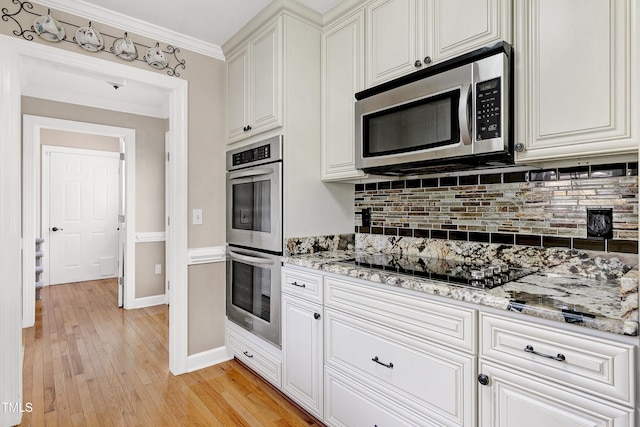 2709 Les Paul Ln, Apex, NC 27539 - kitchen featuring stainless steel appliances, light wood-style floors, decorative backsplash, light stone countertops, and white cabinetry