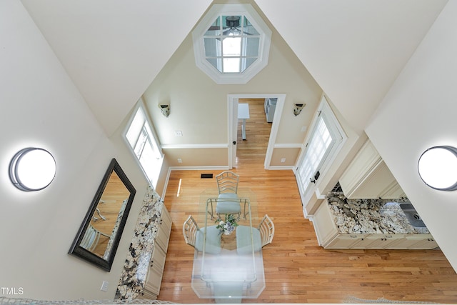2709 Les Paul Ln, Apex, NC 27539 - living area with a high ceiling, light wood finished floors, ceiling fan, and baseboards