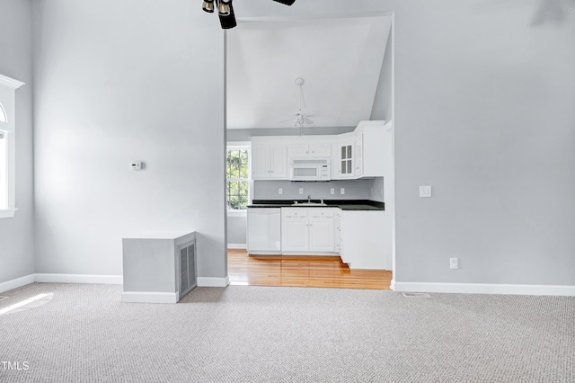 2709 Les Paul Ln, Apex, NC 27539 - kitchen featuring a ceiling fan, white appliances, light carpet, a sink, and high vaulted ceiling