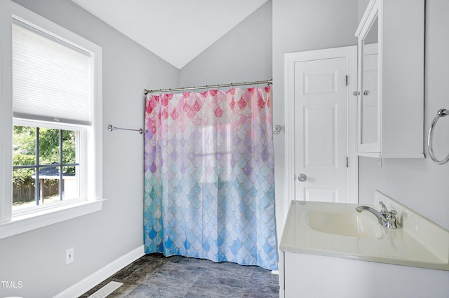 2709 Les Paul Ln, Apex, NC 27539 - bathroom with vaulted ceiling, vanity, baseboards, and a shower with curtain