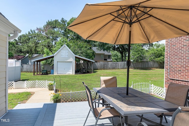 2709 Les Paul Ln, Apex, NC 27539 - wooden terrace featuring outdoor dining area, a detached garage, and an outdoor structure