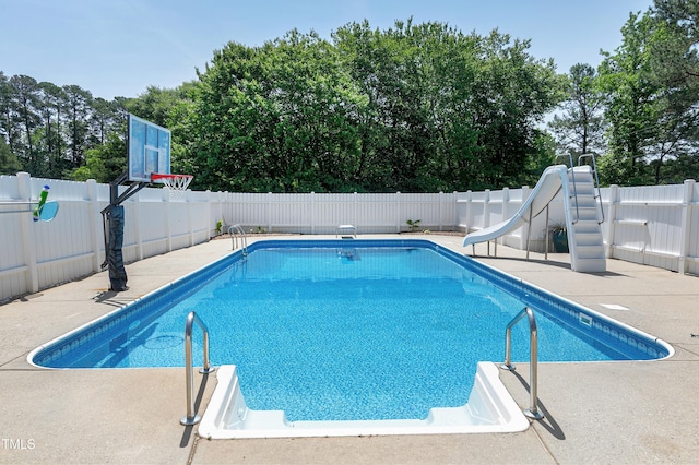 2709 Les Paul Ln, Apex, NC 27539 - view of swimming pool featuring a fenced backyard, a water slide, a patio area, and view of scattered trees