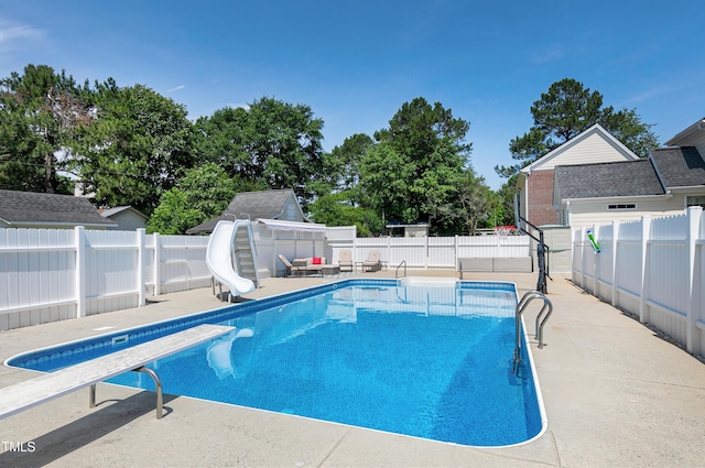 2709 Les Paul Ln, Apex, NC 27539 - view of swimming pool featuring a water slide, a fenced backyard, and a diving board